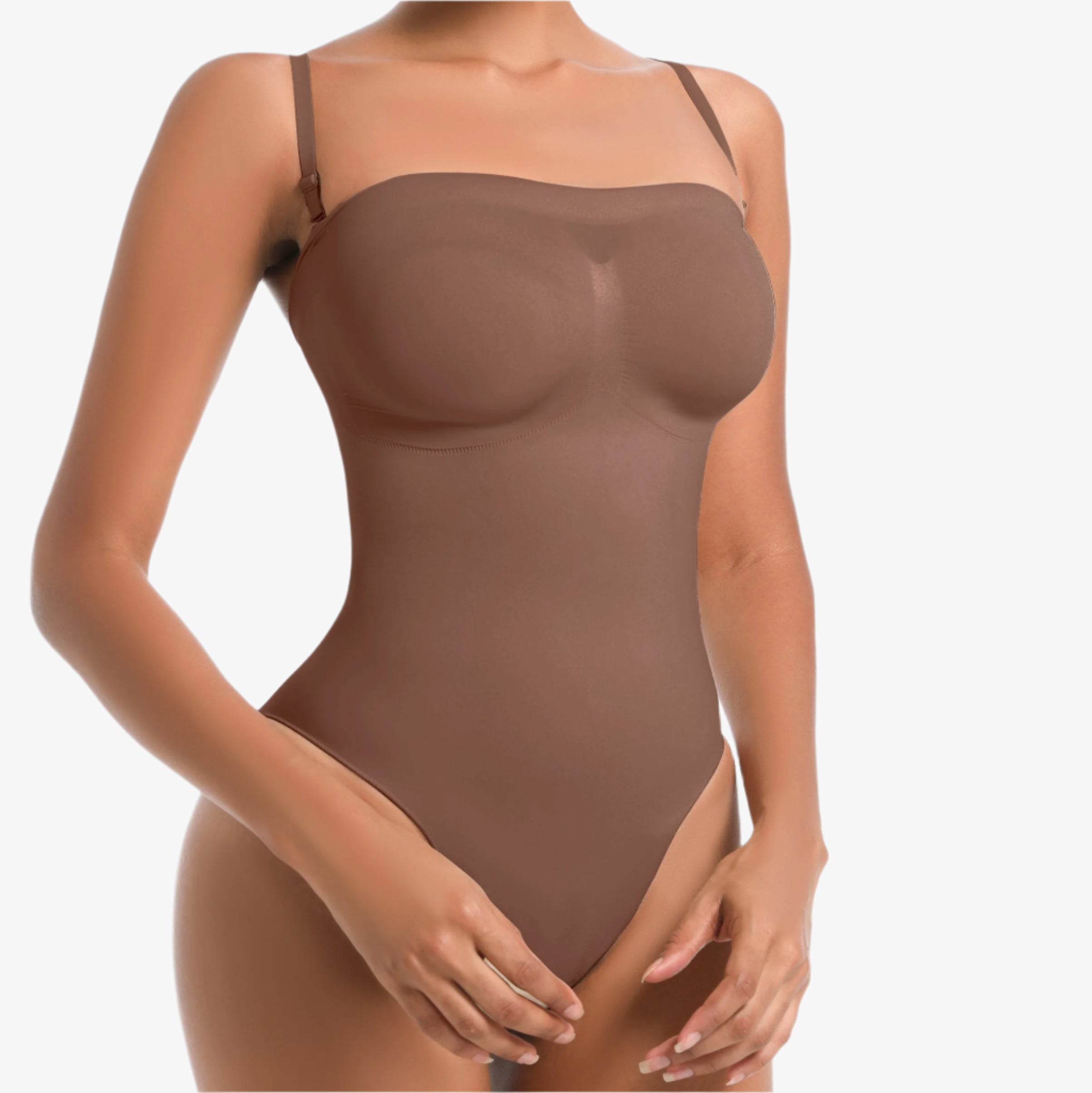 Woman wearing a brown bodysuit on a white background
